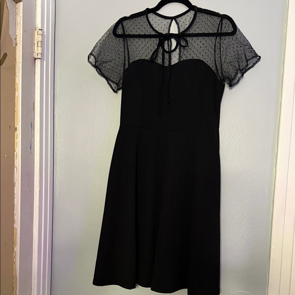 Elegant Black Dress with Sheer Polka Dot Sleeves